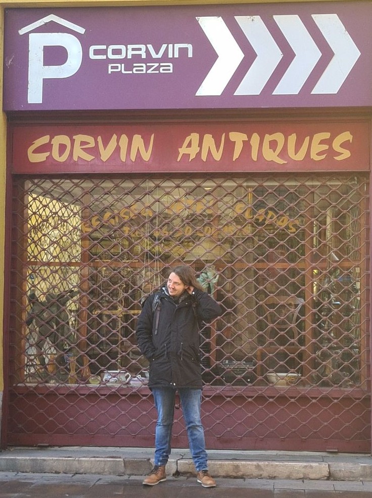 Standing in front of Corvin Antiques in Budapest